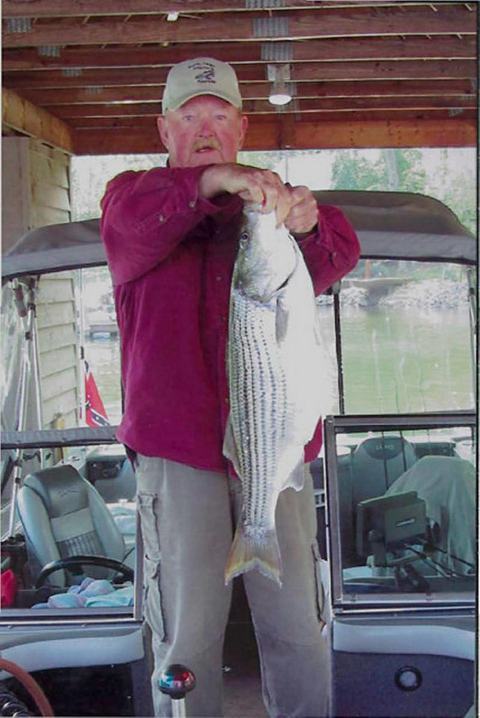 In this 2012 Charlotte Observer file photo, veteran Lake Norman fisherman Sam “Rawhide” Newman of Mooresville holds a 9-pound striper he caught on the lake. Newman recalls “breezing down” N.C. 150 in Mooresville to the lake in the 1970s at 55 or 60 mph. Traffic “was light,” and no businesses existed at I-77 exit 36, he said.