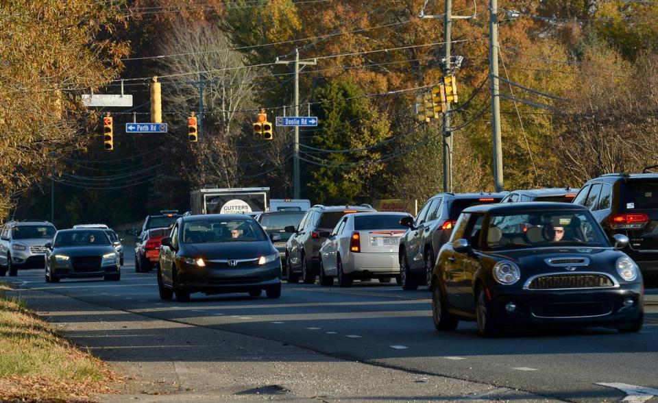 A steady flow of traffic proceeds through an intersection on N.C. 150 west of Mooresville, NC, on Wednesday, November 17, 2021.