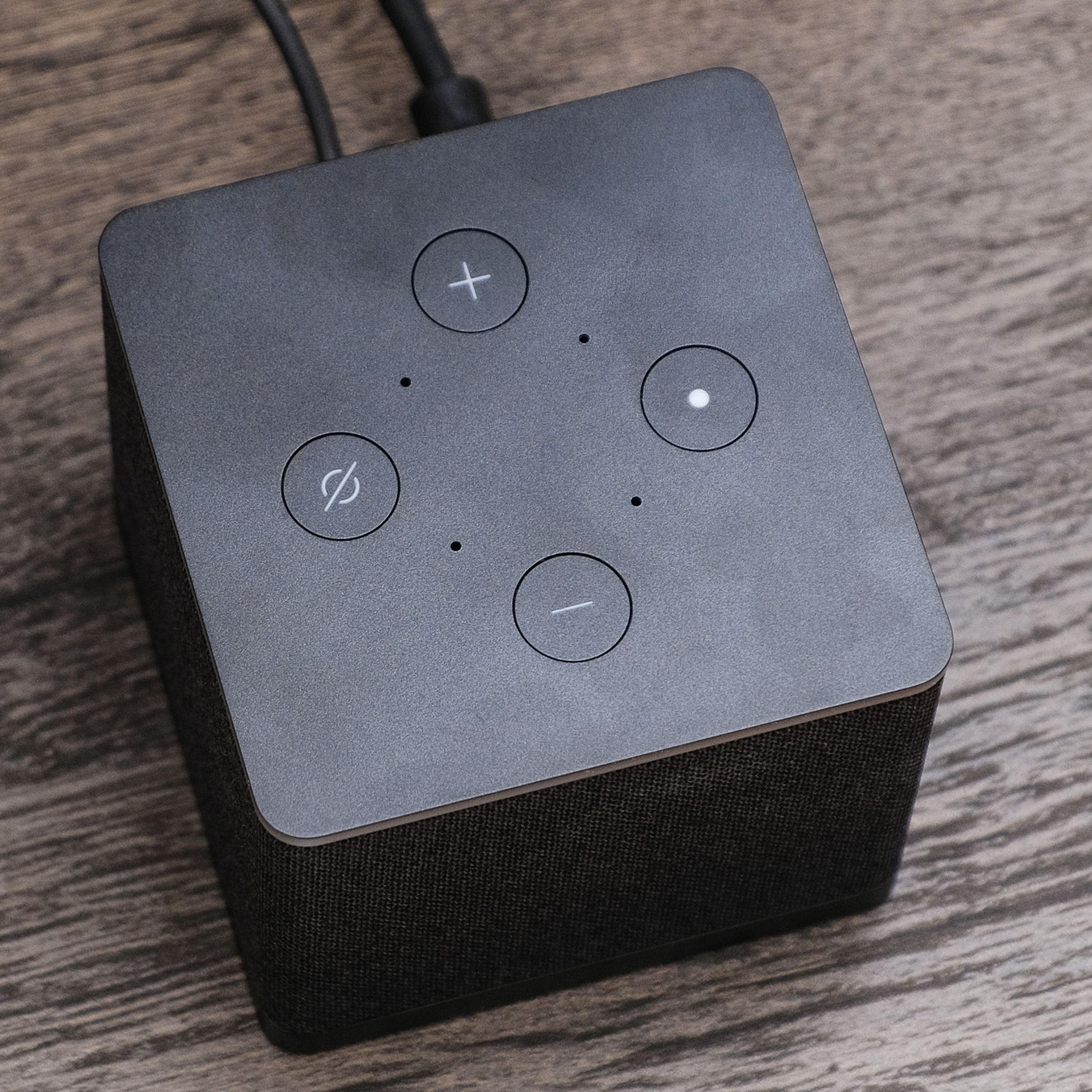 A photo of Amazon’s Fire TV Cube on a TV stand.