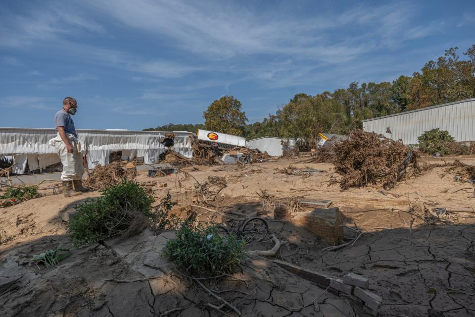 Seth Feur, an employee of WNC Tile, looks at the foundation of where the Drye home once stood at Swannanoa River Road in Asheville.