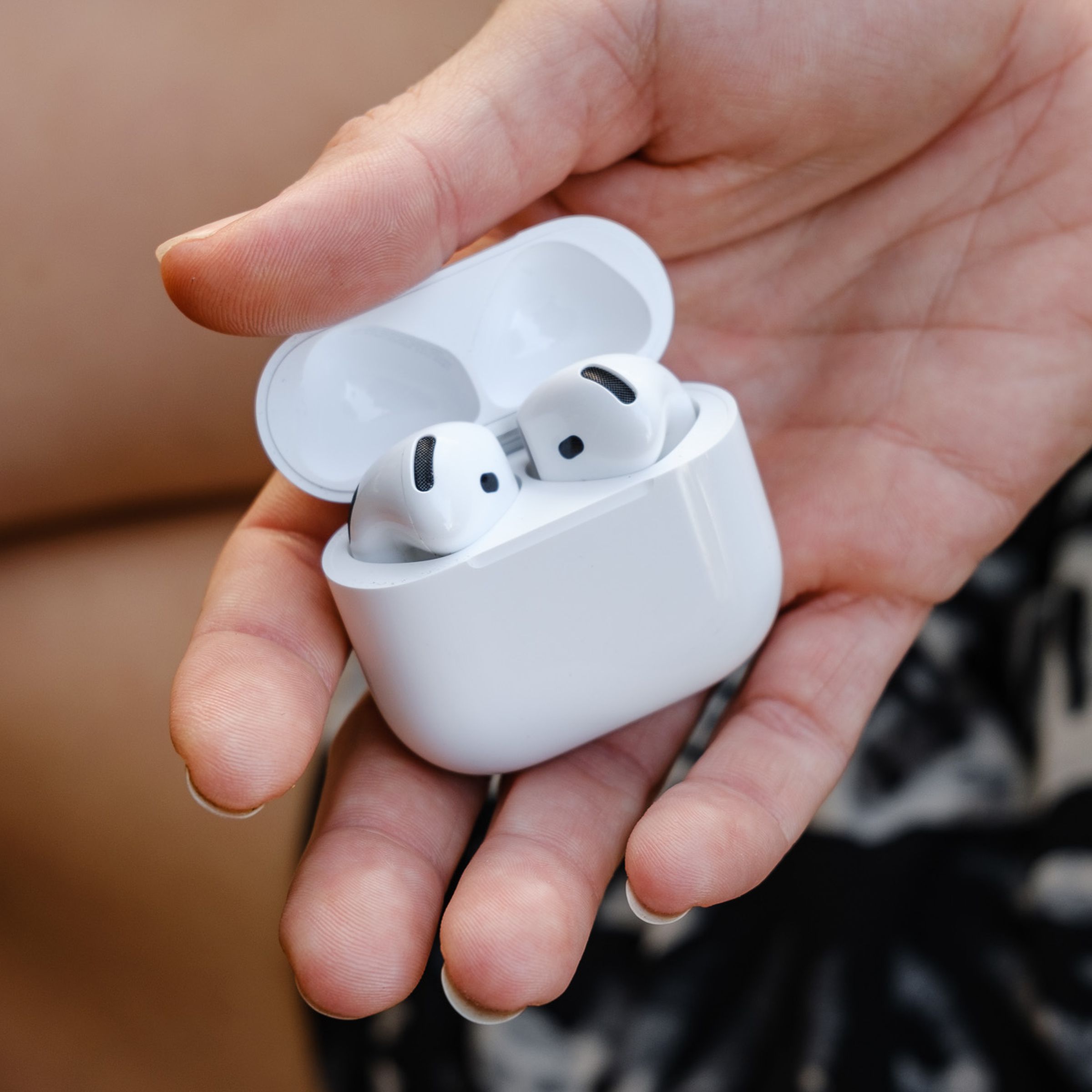 A hands-on photo of Apple’s AirPods 4 wireless earbuds.