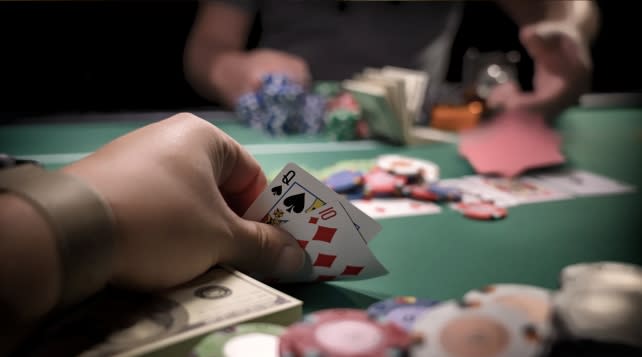 Hand holding cards during a game of poker