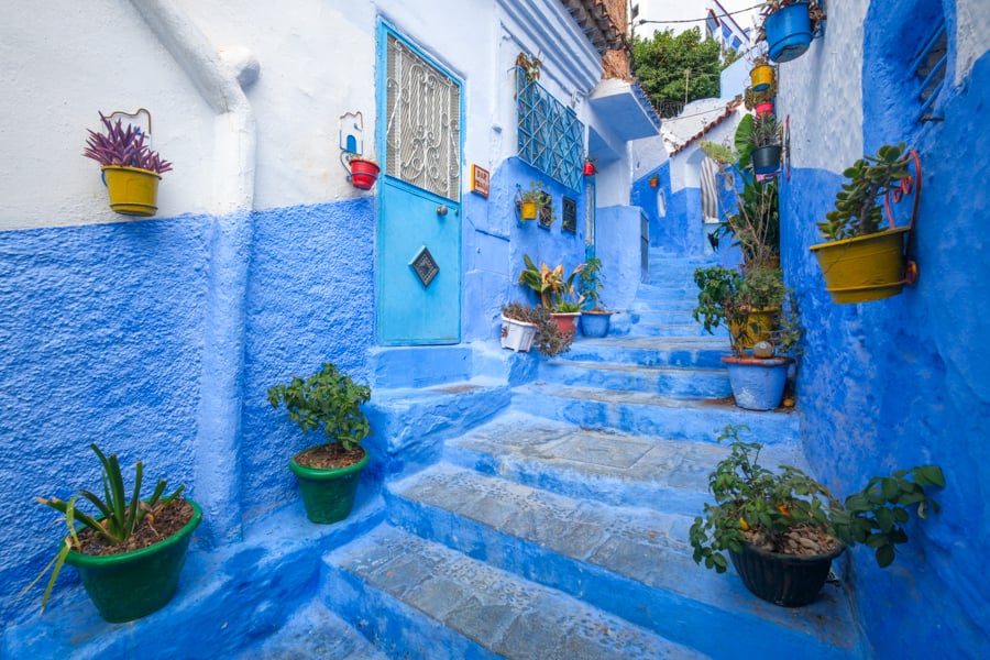 Alley of colorful flower pots, blue city, Chefchaouen, Morocco
