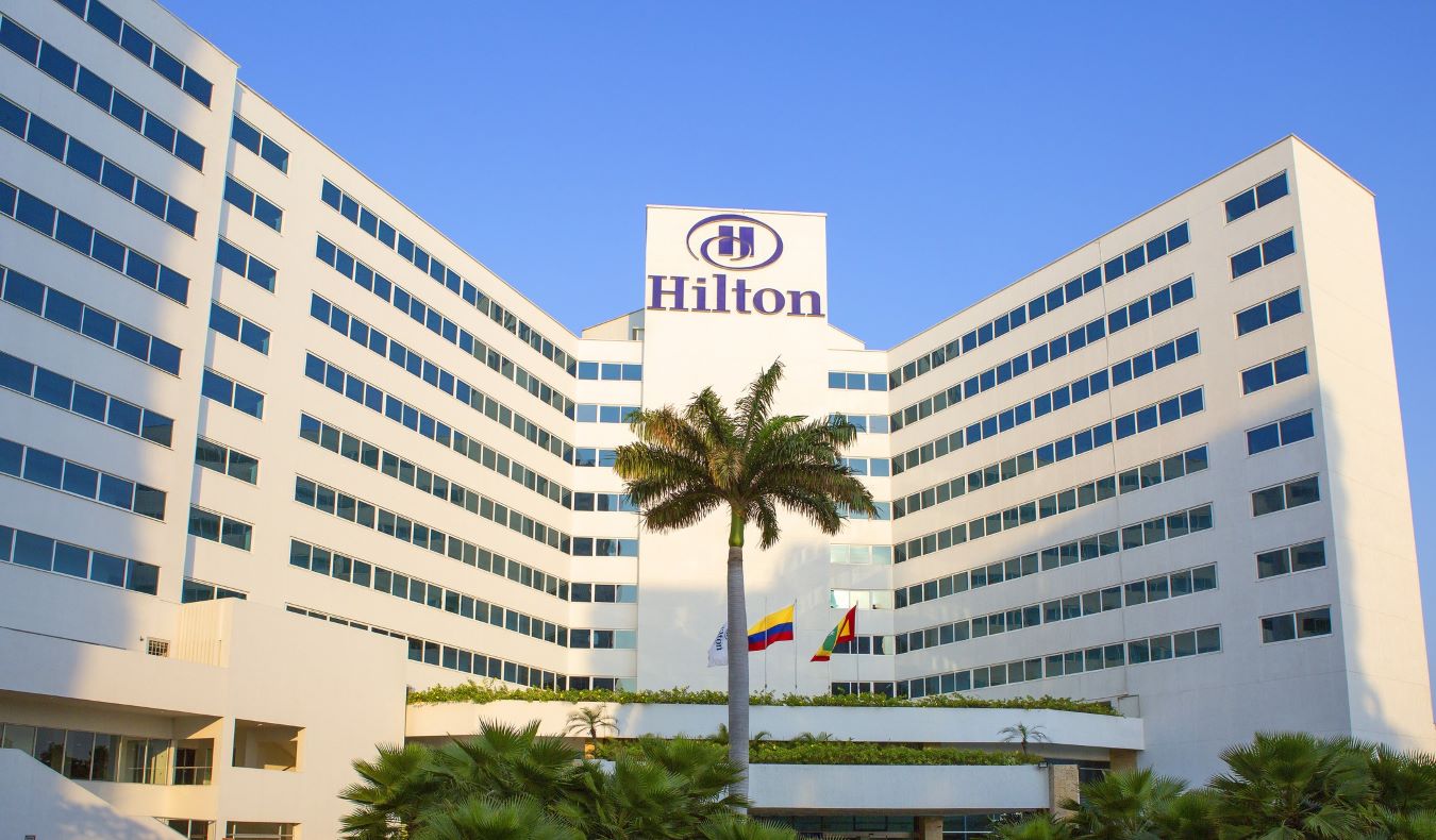 A Hilton hotel in Cartagena, Colombia, with a large palm tree in front of it