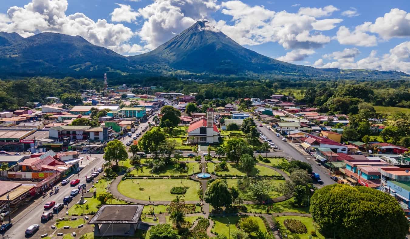 Air view of La Fortuna with Arenal Volcano in the background on a sunny day in Costa Rica
