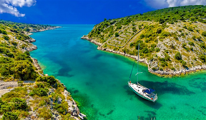 Sailing boats floating on a narrow river with beautiful turquoise water