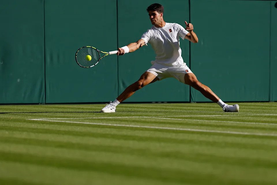 Jun 30, 2025; Wimbledon, United Kingdom; Carlos Alcaraz (ESP) reaches for a forehand against Fabio Fognini (ITA)(not pictured) on day one of The Championships, Wimbledon 2025 at All England Lawn Tennis and Croquet Club. Mandatory Credit: Geoff Burke-Imagn Images