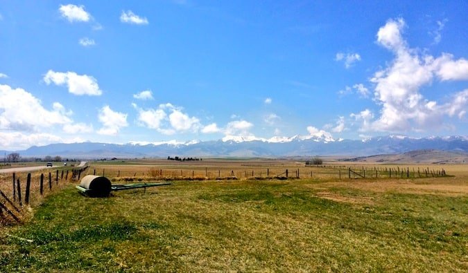 A flat, sparse farmyard in rural Montana during the summer
