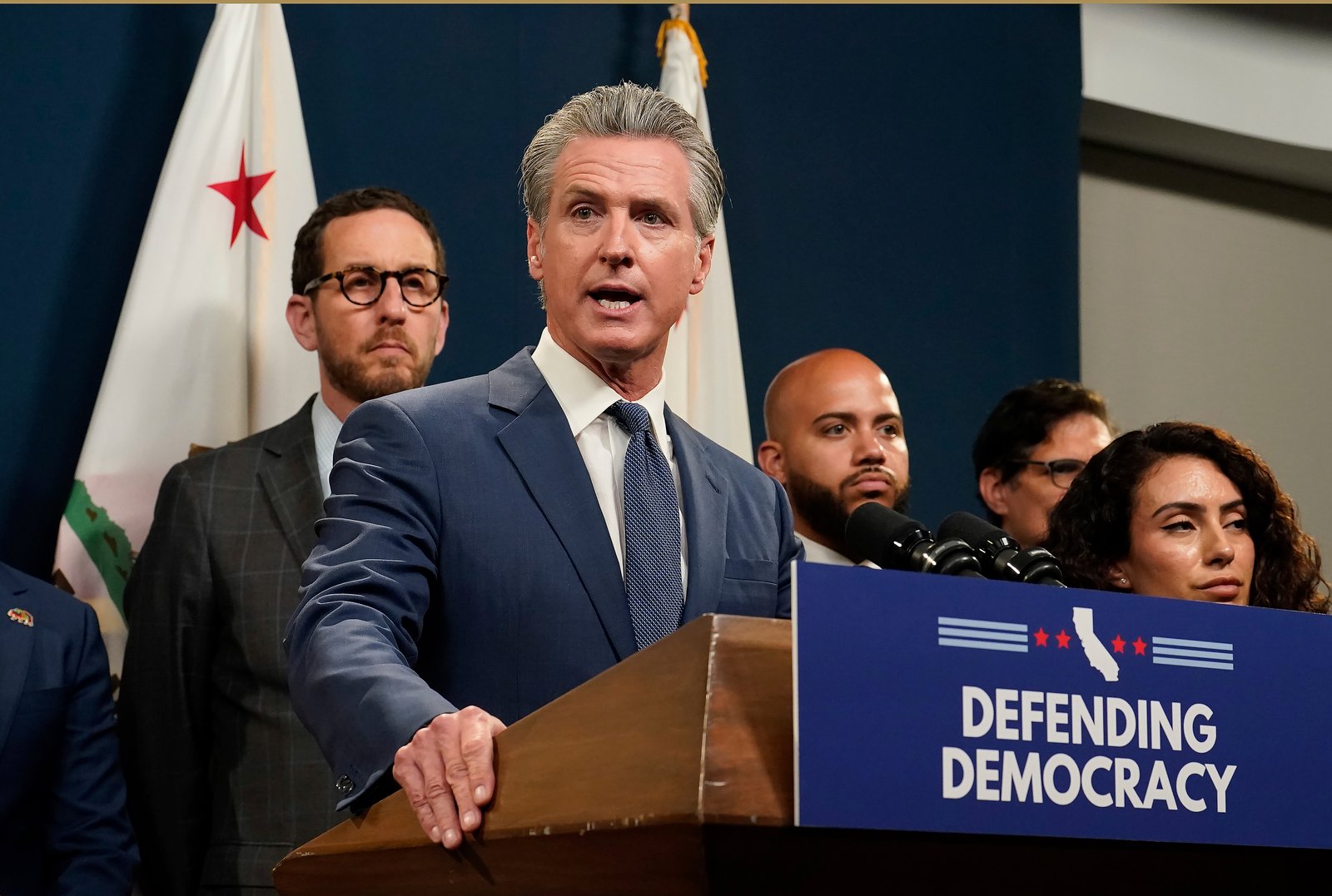 California Gov. Gavin Newsom addresses reporters on Thursday after signing the gerrymandering legislation to put new maps before voters in a special election.