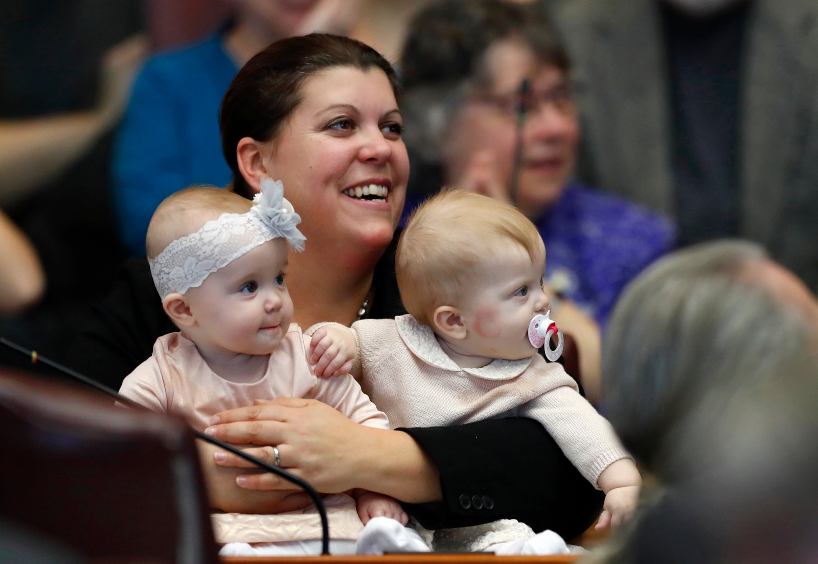 Then-state Rep. Genevieve McDonald, shown above holding her children in the Maine House chamber in 2018.