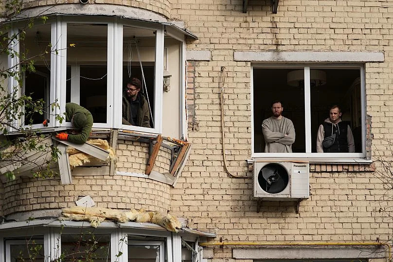Men begin repairing a damaged apartment building after the Russian attack in Kiev, October 23, 2025
