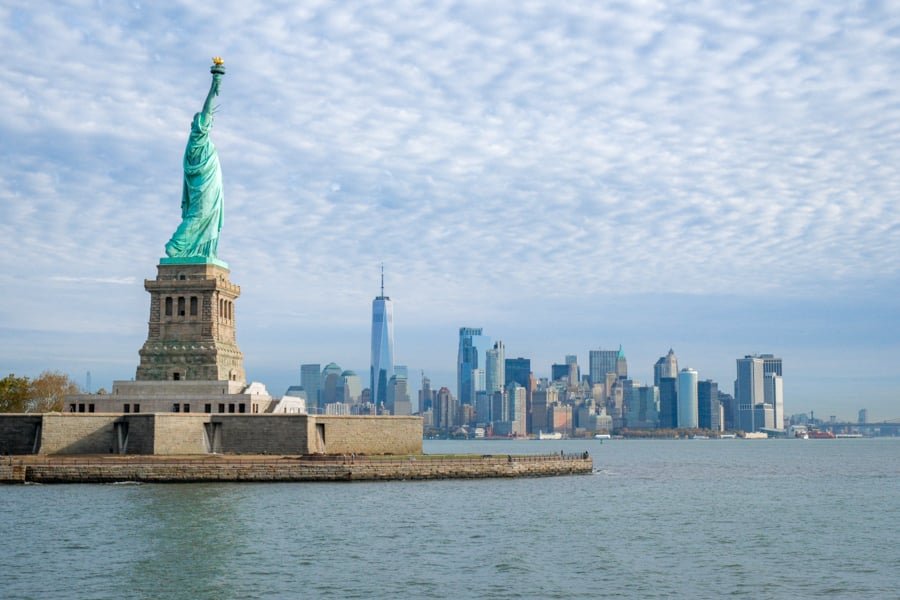 Statue of Liberty island with Manhattan skyline in the background