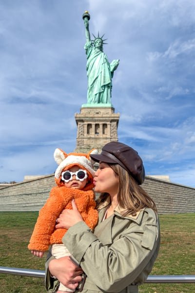 Posing with the Statue of Liberty in New York City