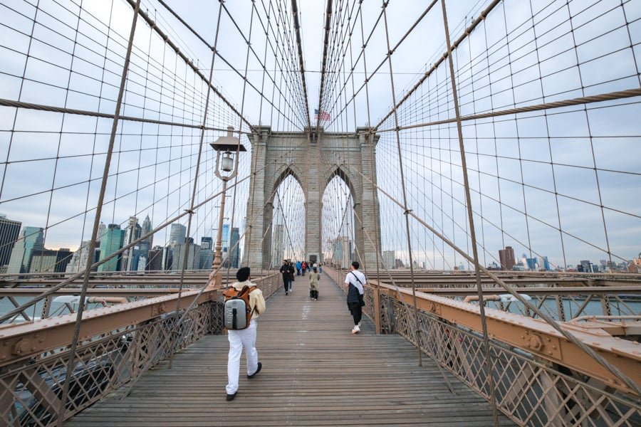 Walking across Brooklyn Bridge in New York City