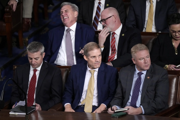 Rep. Jim Jordan, sits with Rep. Warren Davidson, right. At rear, Kevin McCarthy shares a laugh with Rep. Derrick Van Orden. 