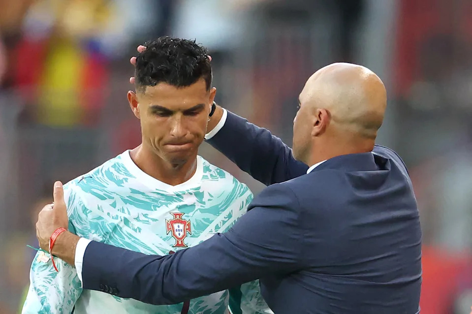 TOPSHOT - Portugal's forward #07 Cristiano Ronaldo is greeted by his Spanish head coach Roberto Martinez after being substituted during the 2026 World Cup round of 32 football match between Portugal and Croatia at the Toronto Stadium in Toronto on July 2, 2026. (Photo by Cole Burston / AFP via Getty Images)