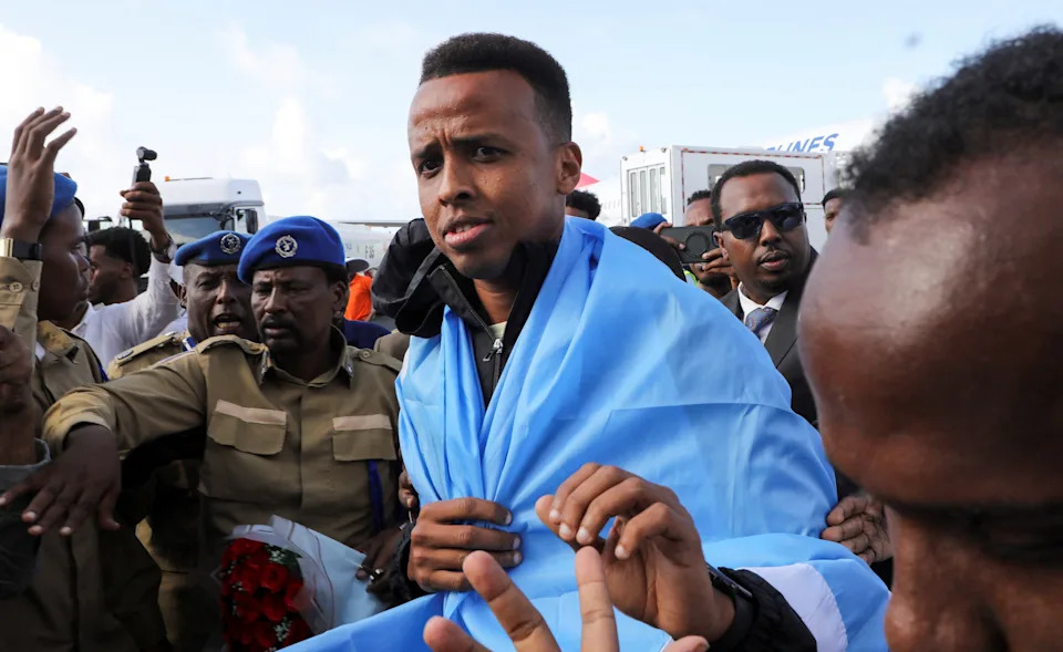 Somali referee Omar Abdulkadir Artan, who had been expected to officiate at matches during the 2026 FIFA World Cup but was denied entry to the United States, is received as he arrives at the Aden Abdulle Osman International Airport in Mogadishu, Somalia June 10, 2026. REUTERS/Feisal Omar