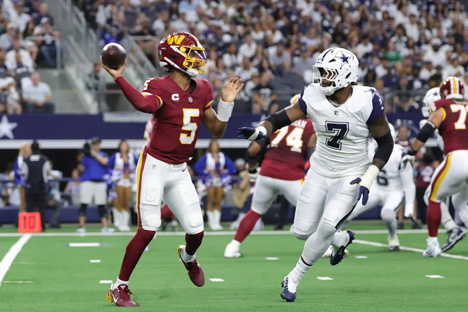 Sep 20, 2026; Arlington, Texas, USA;  Washington Commanders quarterback Jayden Daniels (5) throws a pass against Dallas Cowboys linebacker Rashan Gary (7) during the first half at AT&T Stadium.  Mandatory Credit: Kevin Jairaj-Imagn Images