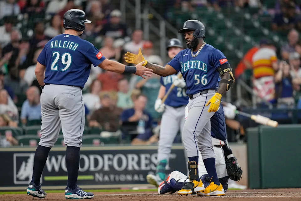Seattle Mariners' Randy Arozarena (56) celebrates with Cal Raleigh (29) after hitting a two-run home run against the Houston Astros during the second inning of a baseball game Tuesday, May 12, 2026, in Houston. (AP Photo/David J. Phillip)
