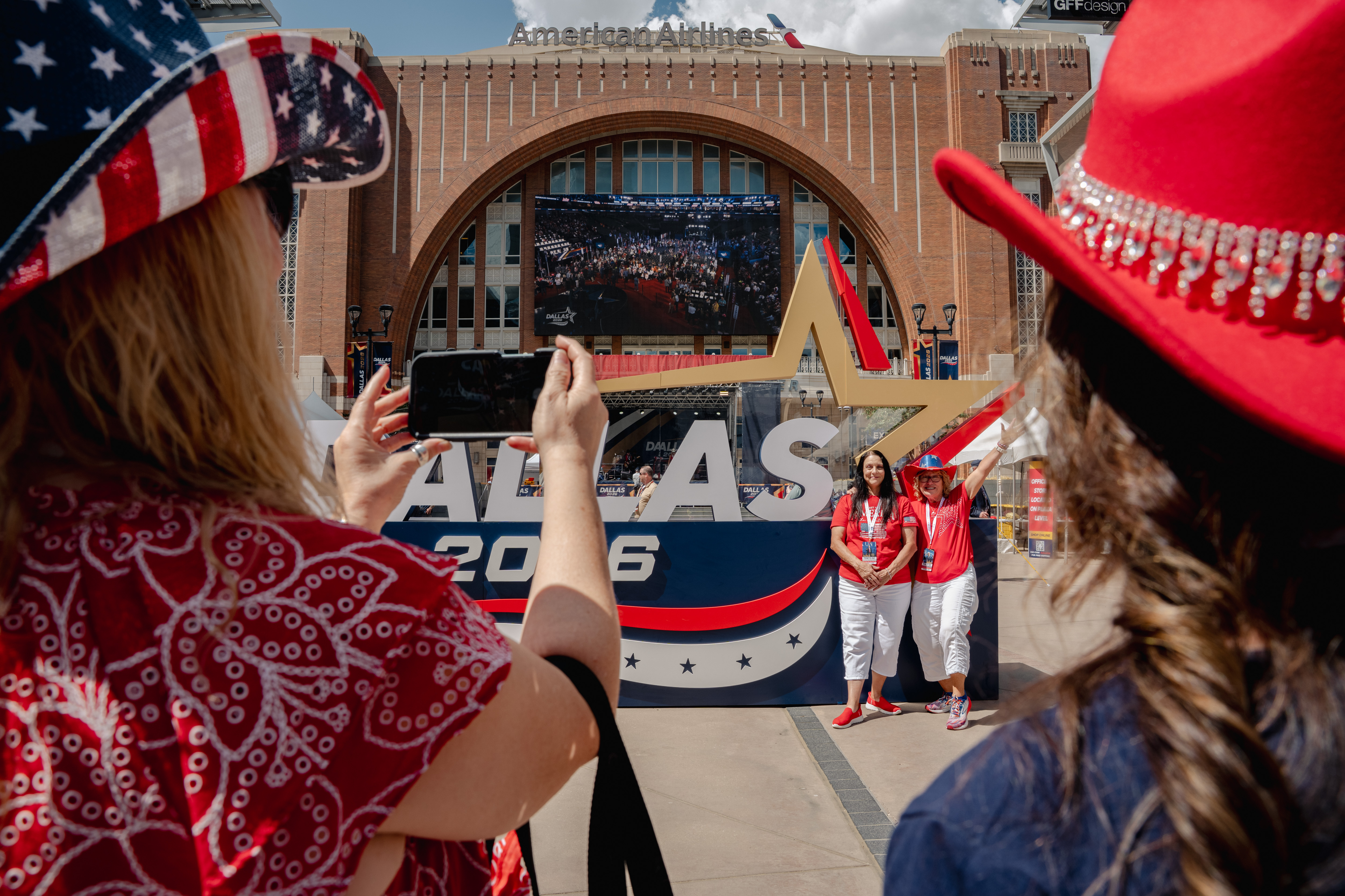 Attendees pose for photos outside the American Airlines Center during the first day of the Republican National Midterm Convention in Dallas on September 9, 2026.